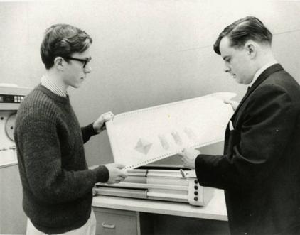 Here Gus German (right), a computer analyst with the Computing Centre, and a student display a printout produced by the plotter