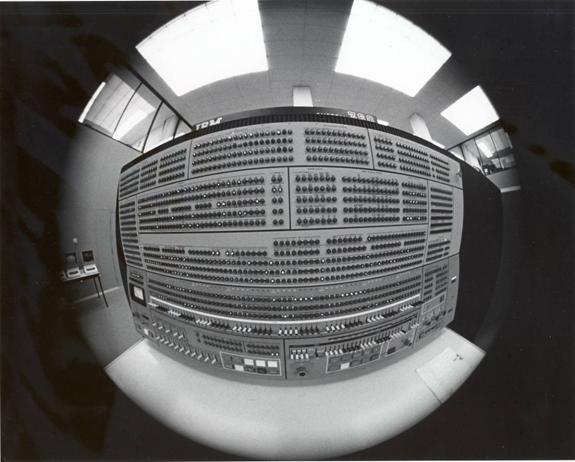In the mid-1970s, the IBM 360/75 was being re-equipped with new internal and peripheral hardware.  This picture shows the 360’s control console circa 1968.  This photo also uses a unique “fish-eye shot.”